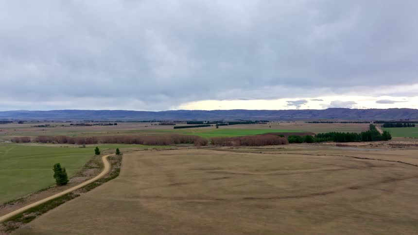 Expansive rural landscape with fields in various shades of brown and green