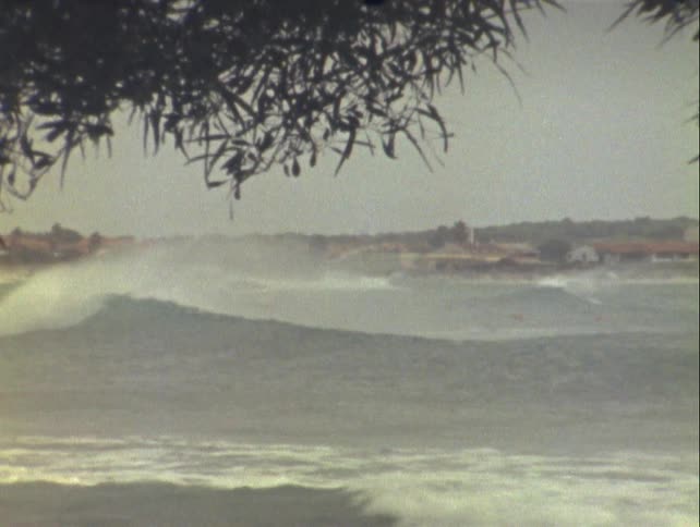 Small boat floating in a sea with strong waves