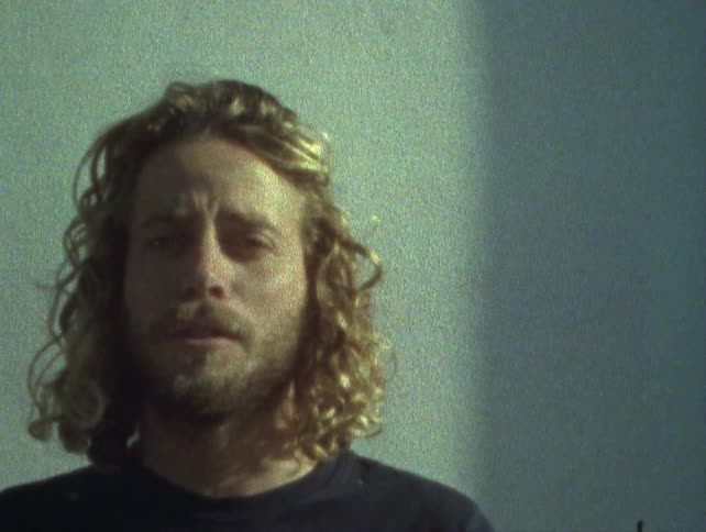 Portrait of a man with a beard and blond hair talking