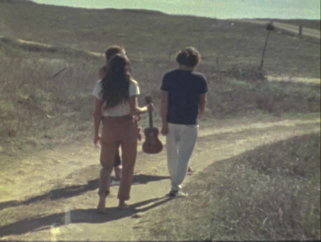 Friends strolling along a rural path captured on vintage film
