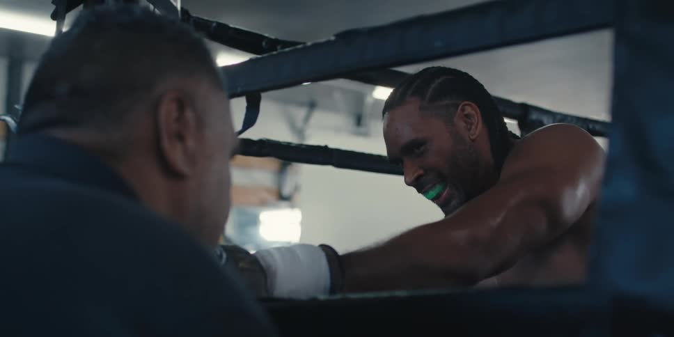 Man talking to his athlete in a boxing ring