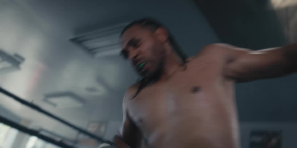 Man in a boxing ring brutally beating another man who is passed out