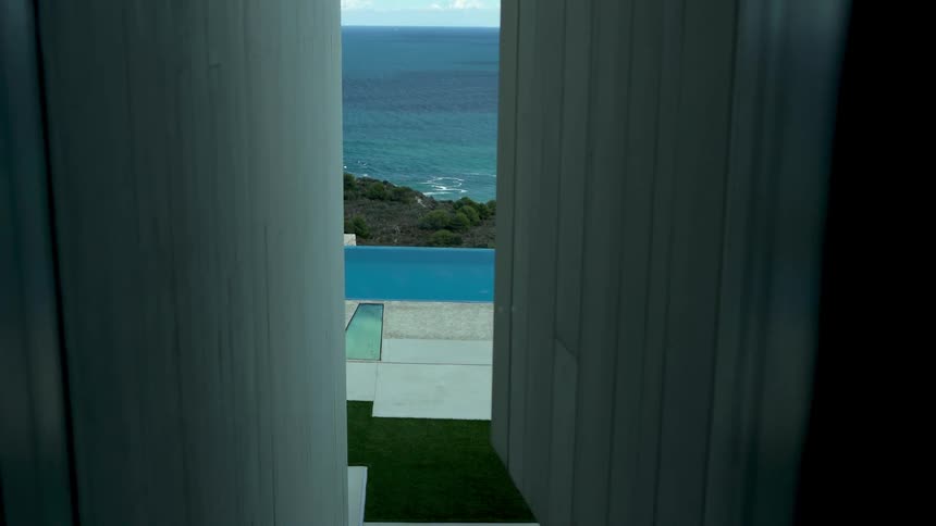 A building and pool are by the shore