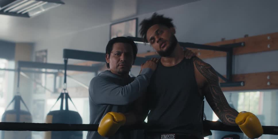 A man is coaching a boxer in his corner