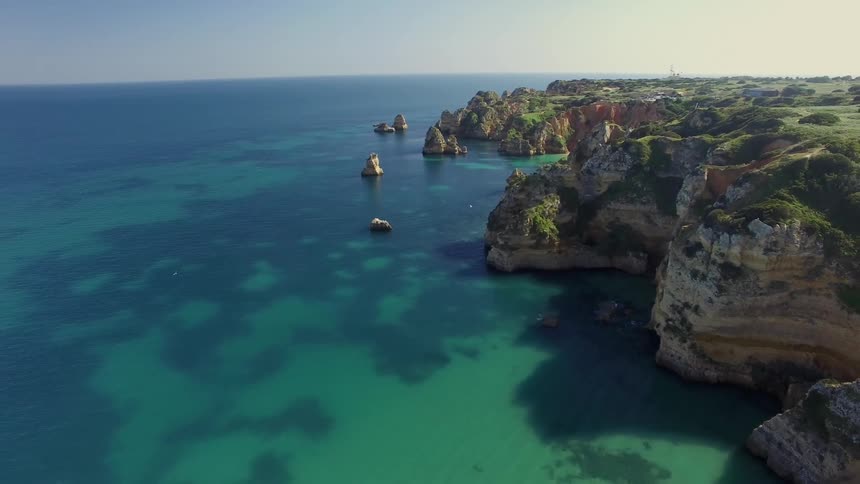 Aerial landscape of a mountainous crust on the edge of a turquoise green sea