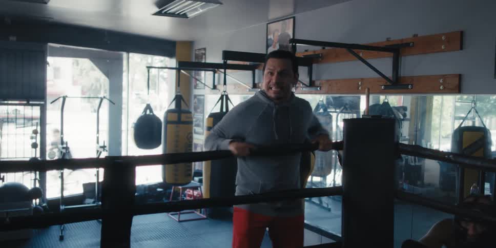 Boxing coach yells instructions during a training session in a boxing gym