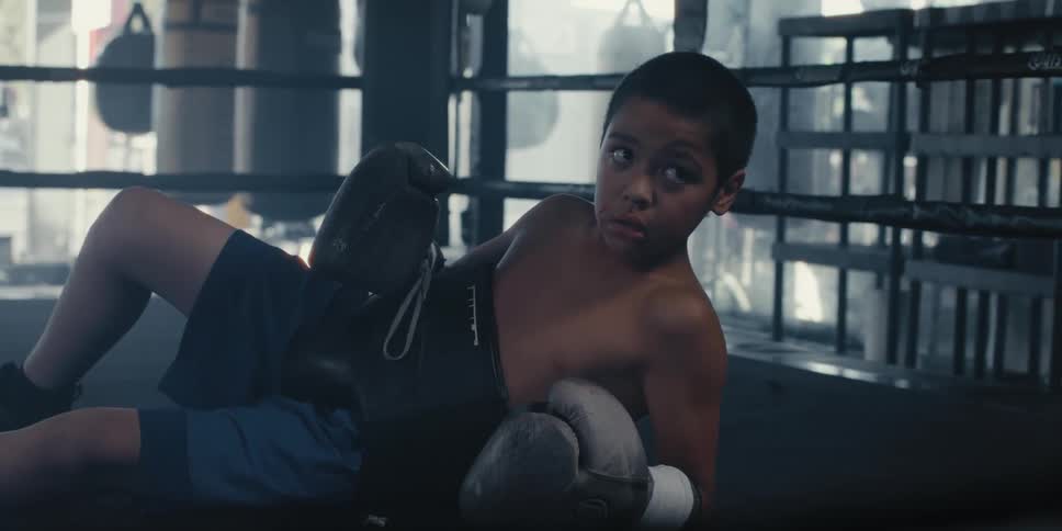 A child is laying in the boxing ring