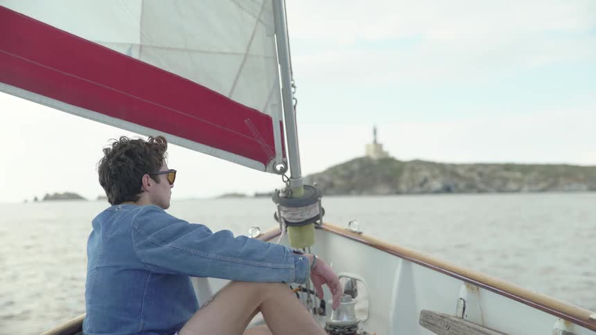Man sitting on the edge of a sailboat