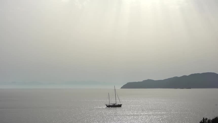 Boat passing through the sea with the coast in the background