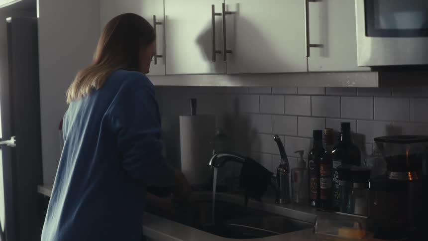 A woman is washing the dishes