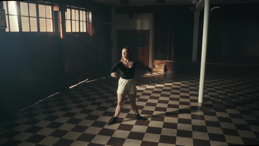Blonde woman dancing in a room alone