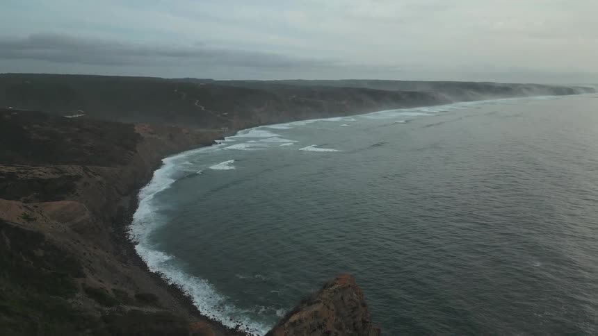 Aerial landscape of a bay with extensive sea and a rocky coast