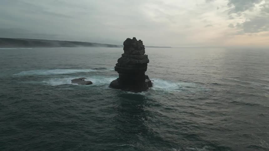 Landscape of a rock with a cliff in the middle of the ocean