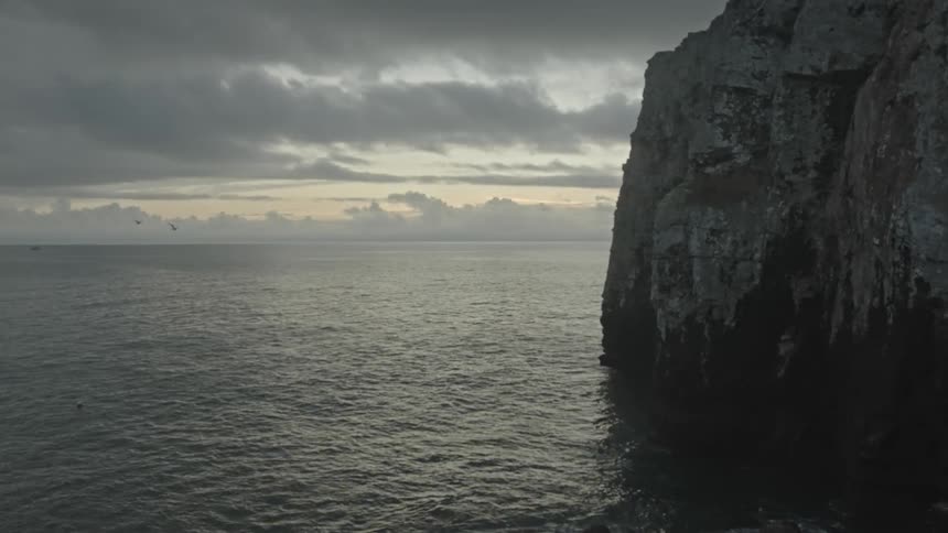 A tall cliff is on the shore