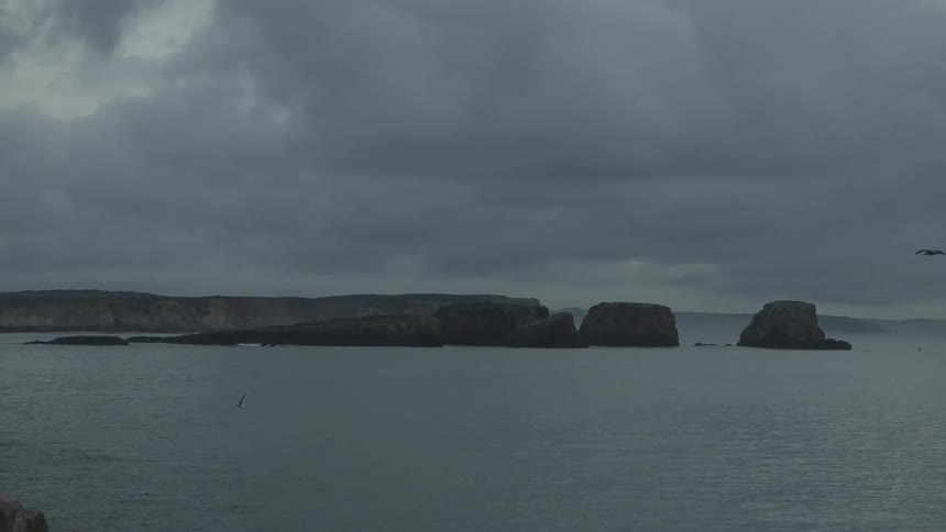 Seascape with the coast in the background on a cloudy day
