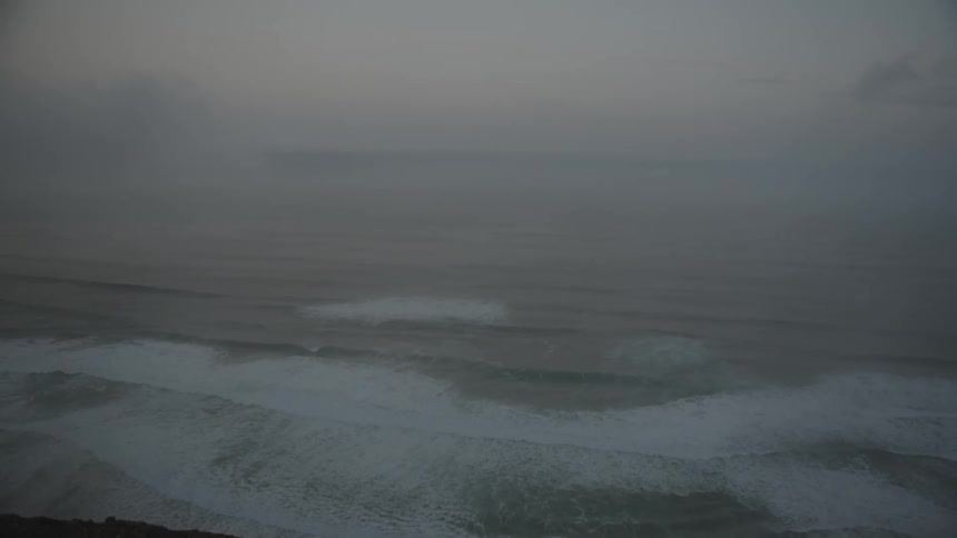 Seascape with strong waves on a cloudy day