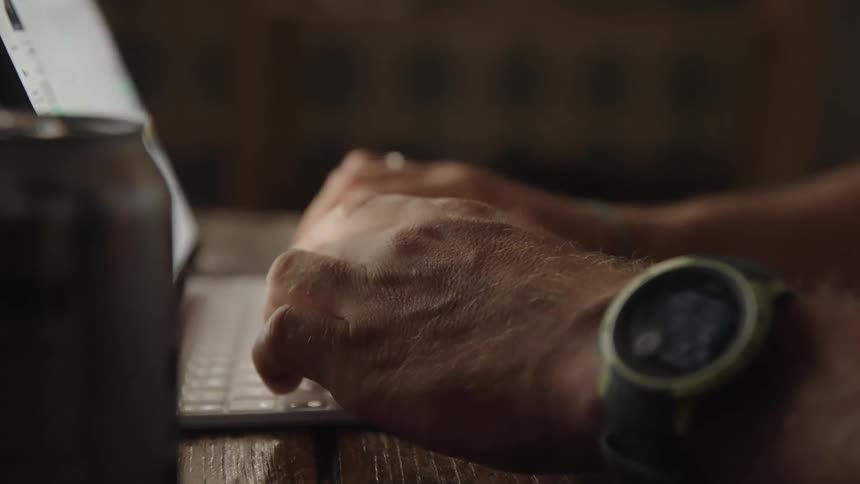 Closeup of a man typing on a laptop computer