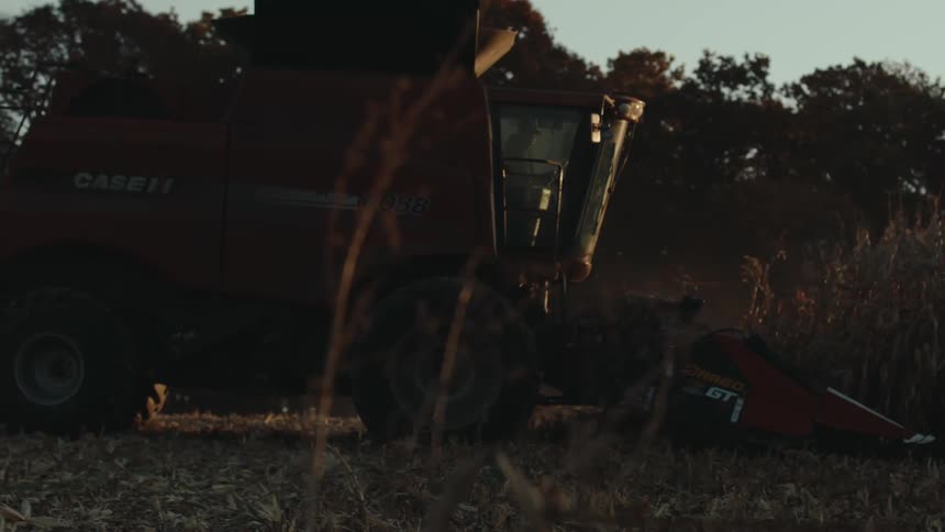 A harvester collects the crops on the farm