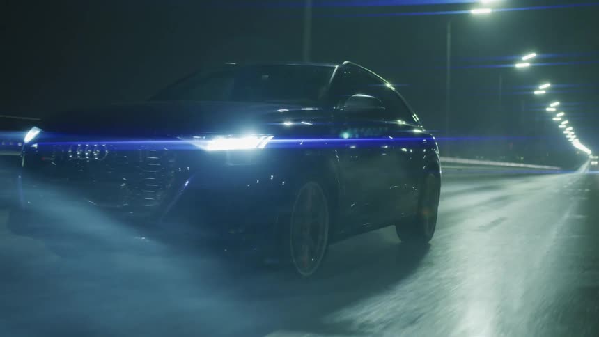 A car travels on the highway at night