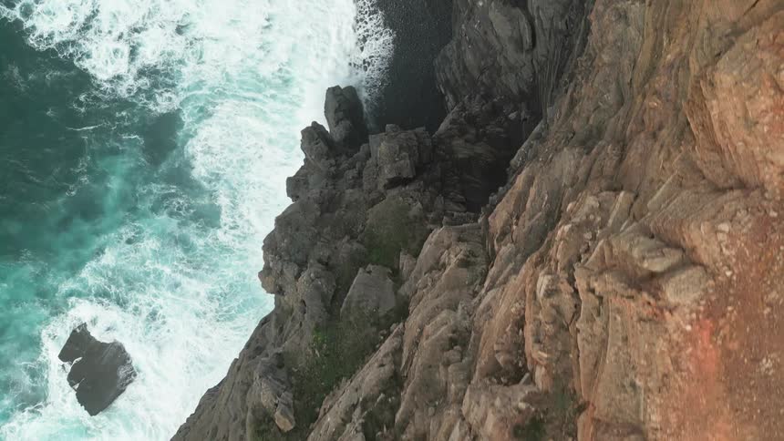 Aerial view of a rocky cliff by the sea