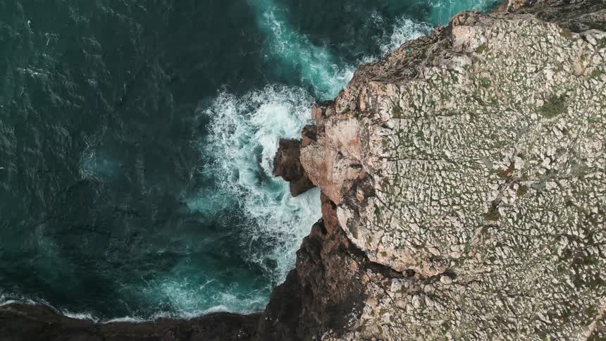Aerial view of a rocky cliff by the sea