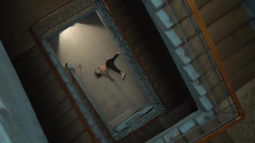 View from above a staircase of a man dancing