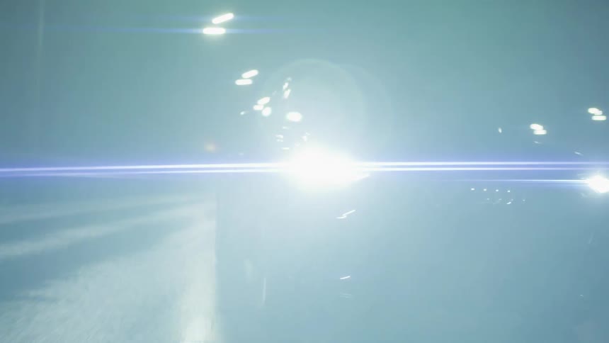 Modern sports car traveling on a highway at night and changing lanes
