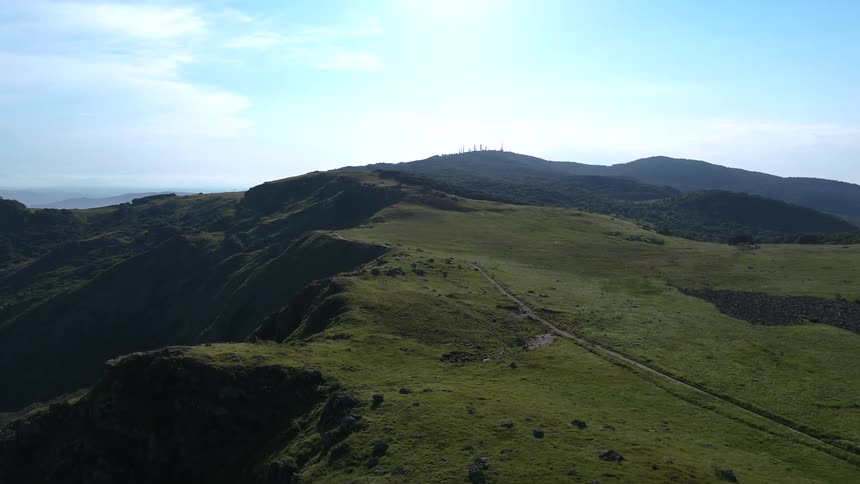 Vast landscape with green hills and clear sky