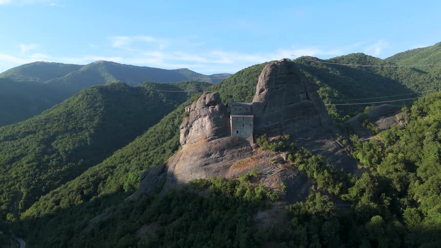 A building is built into the top of a forestcovered mountain