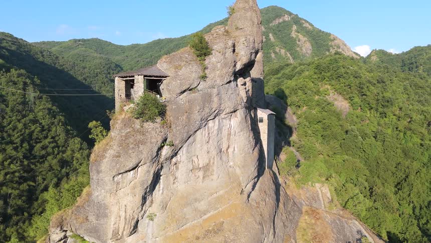 A fortress is built into the peak of the mountain