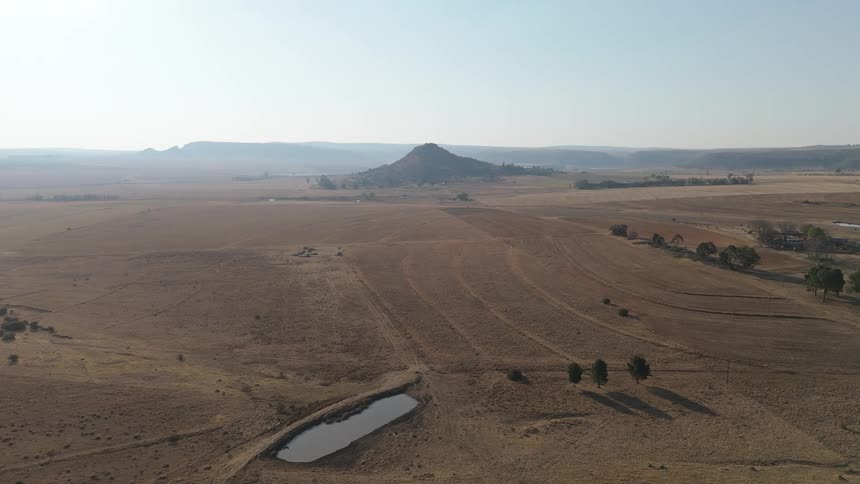 Aerial landscape and arid terrain with the silhouette of mountains on the horizon
