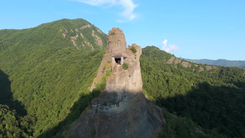 A structure is built into the rocks of the mountain peak