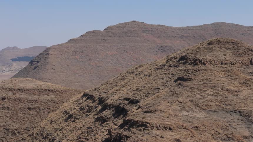 Aerial of a barren mountain range on a sunny day