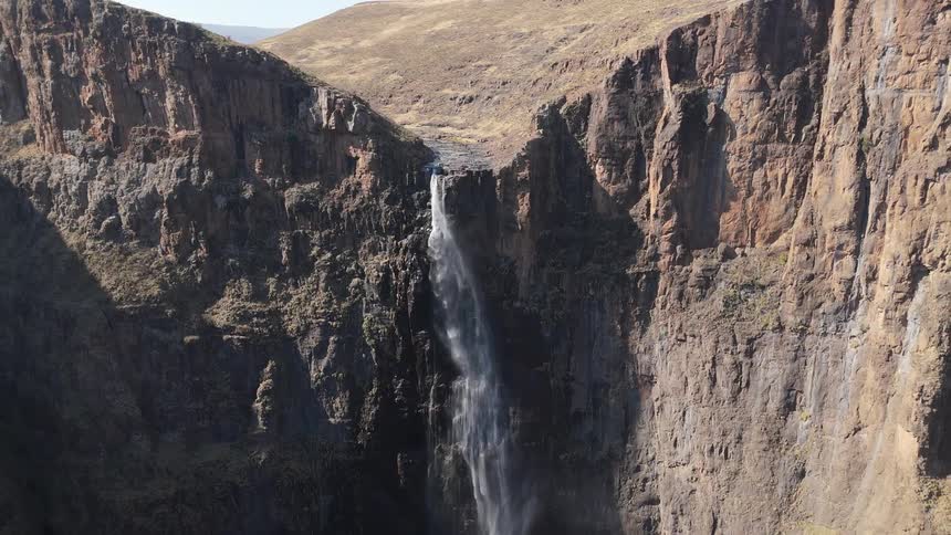 Aerial view of a mountain range with a waterfall in the middle