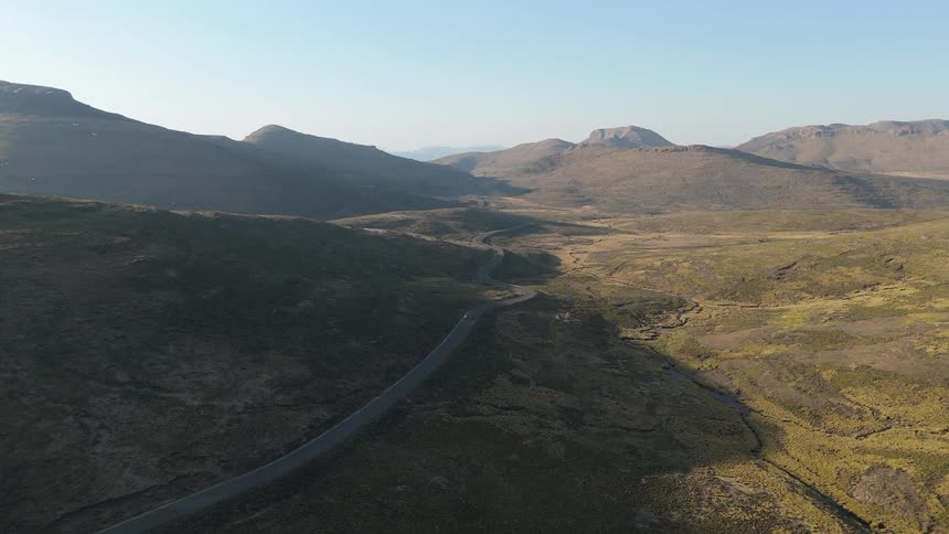 Aerial view of a highway stretch passing through a mountain valley