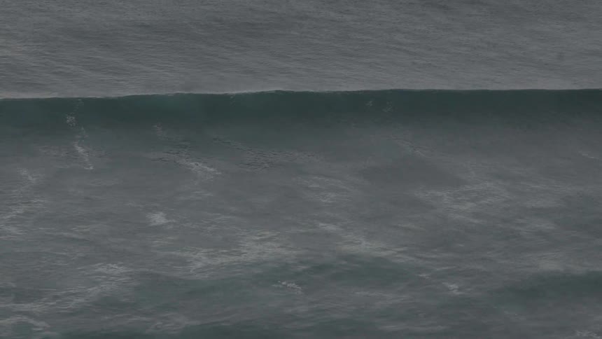 Landscape of a huge wave crashing hard into the ocean