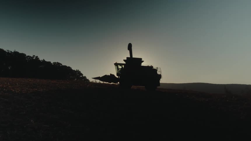 Agricultural machine working in a field one morning