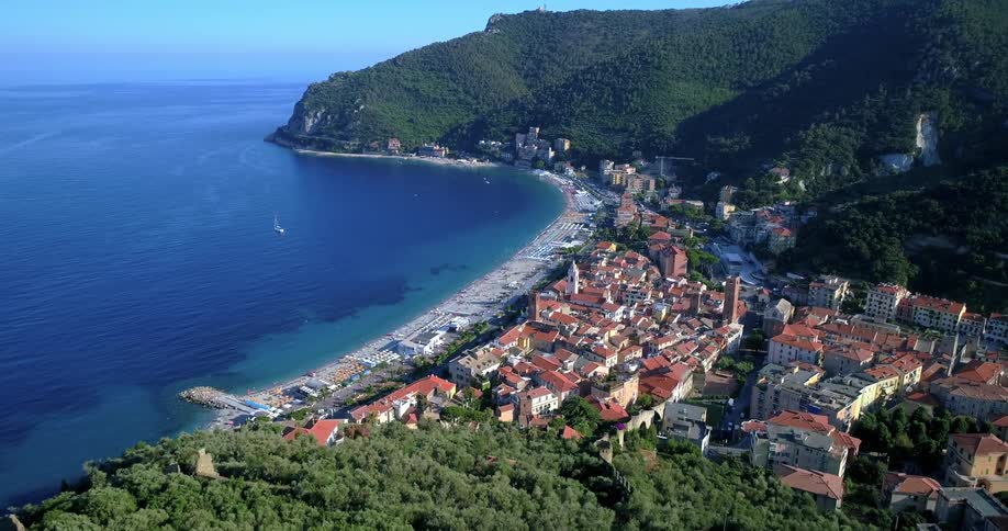 Aerial panorama of an urban seaside city with mountains around
