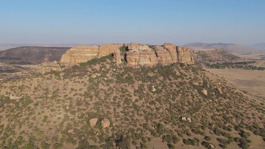 Aerial view of canyons in an arid valley on a blue sky day