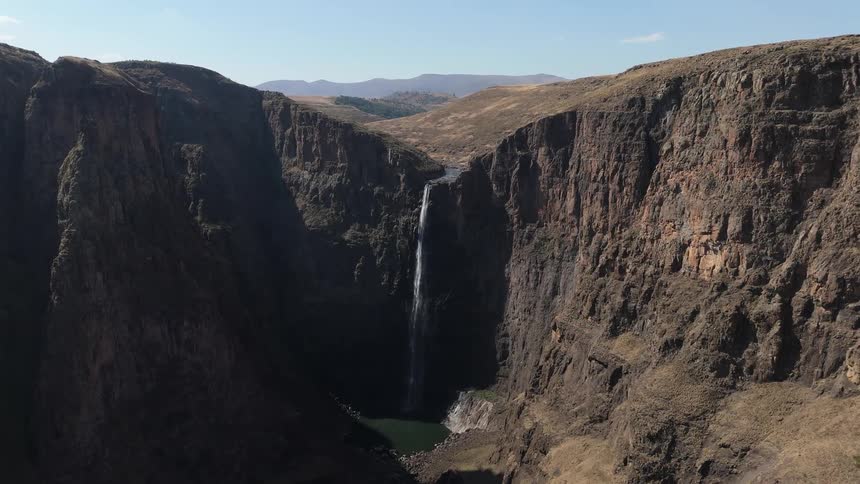 Aerial panorama of a waterfall in a mountain valley