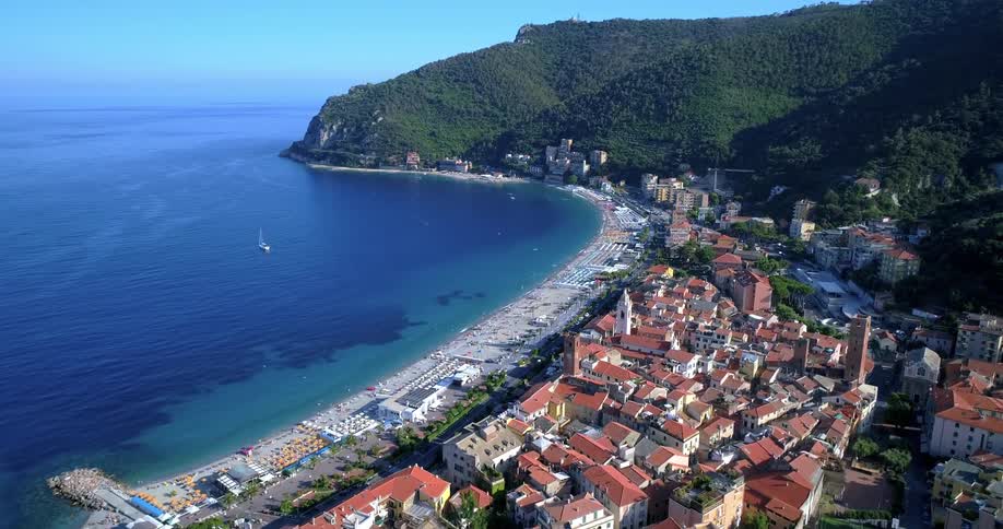 Aerial landscape of an urban city by the sea surrounded by mountains on an island