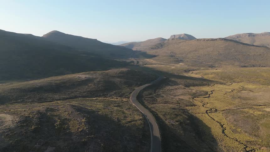 Aerial view of a highway passing through a mountain valley
