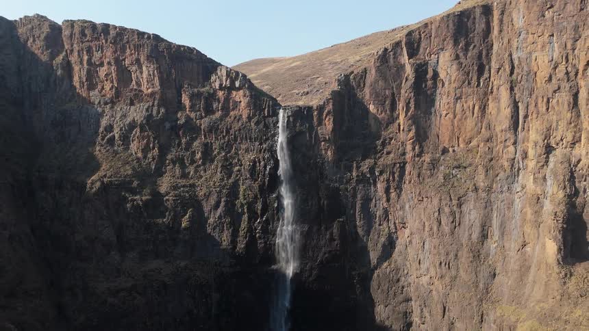 Aerial view of a waterfall in a mountain valley