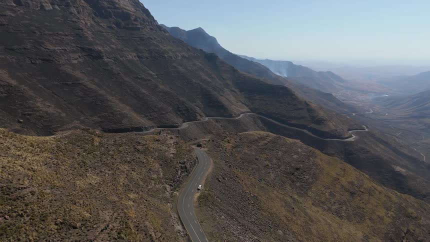 Aerial view of a road winding along mountain cliffs