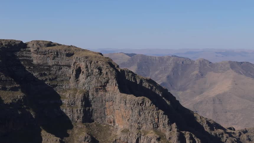 Shadows fall on top of mountains