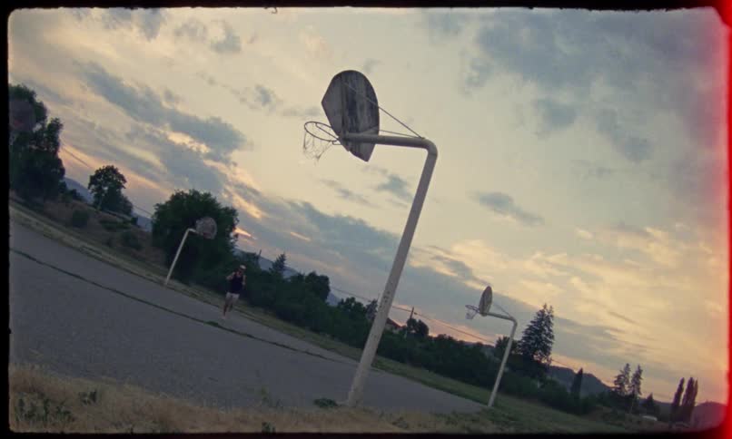 A man is running on a basketball court with some basketball hoops