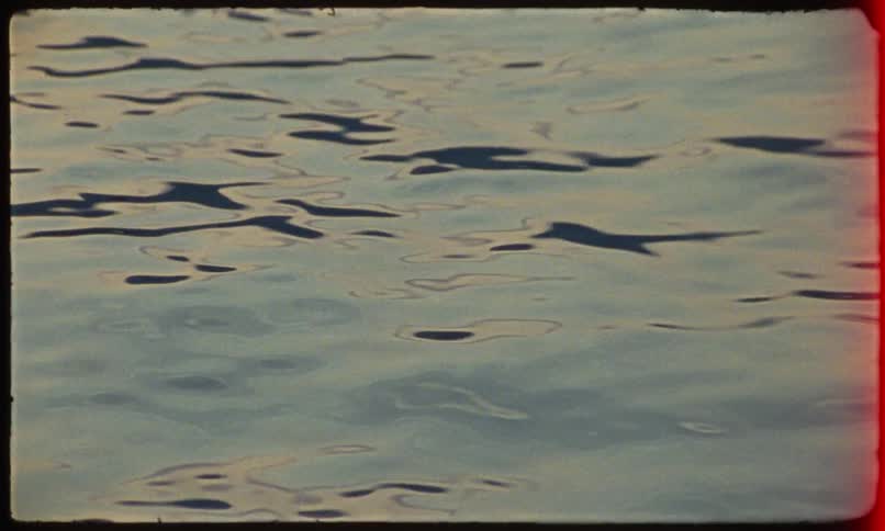 Closeup of water with ripples reflecting light and shadows