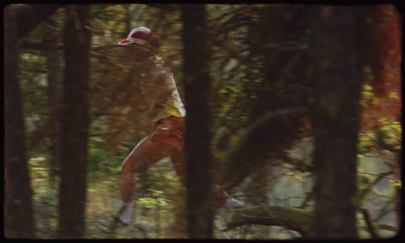 A white woman in shorts jogs through a forest on a path
