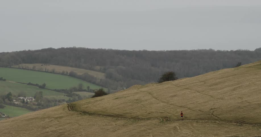 Landscape of a mountain valley and a person running in the background