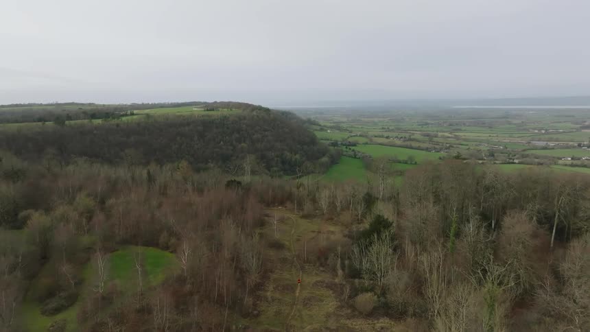 The landscape is green and full of hills